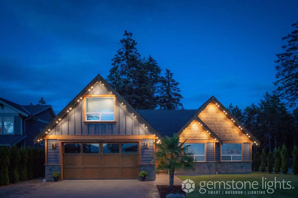 Architectural lighting highlights a beautifully lit house against a twilight sky