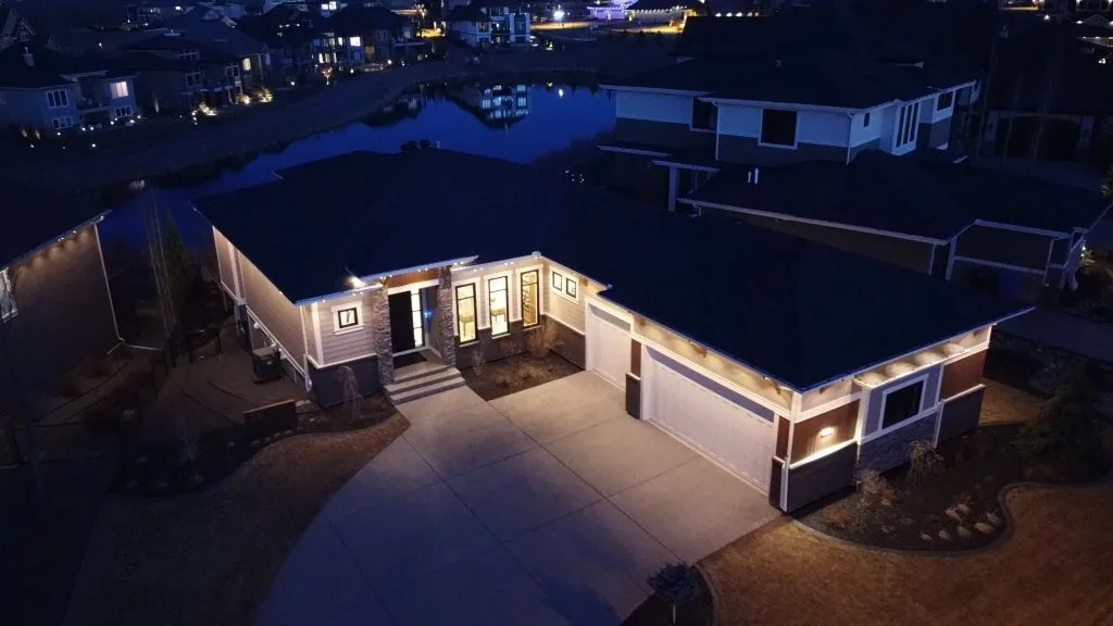 Downlighting highlights the elegant architecture of a house in a dark nighttime setting
