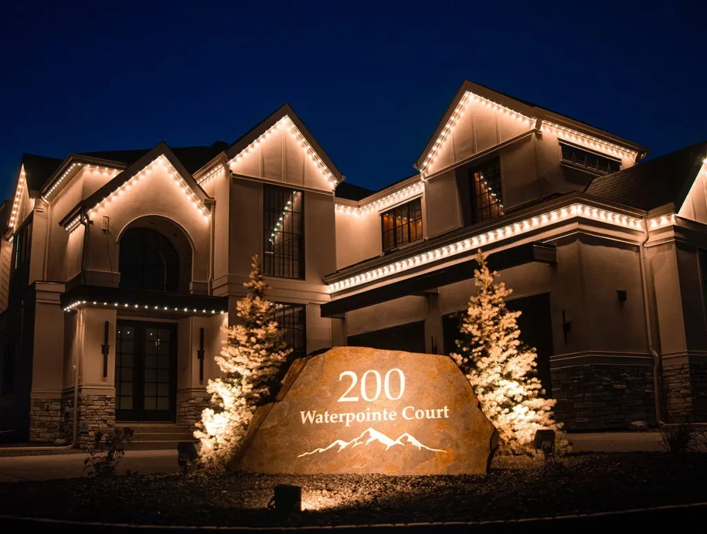 A beautifully lit luxury home showcases elegant architecture against a twilight sky